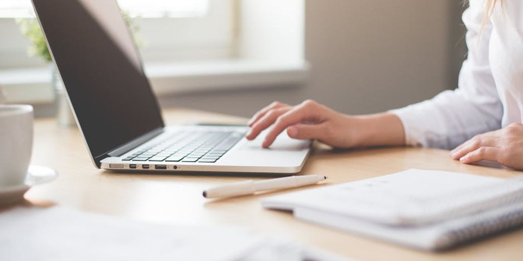 person using laptop with VPN, globe in background, fast internet, secure connection