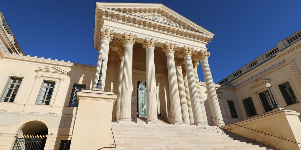 a large building with columns and a clock tower