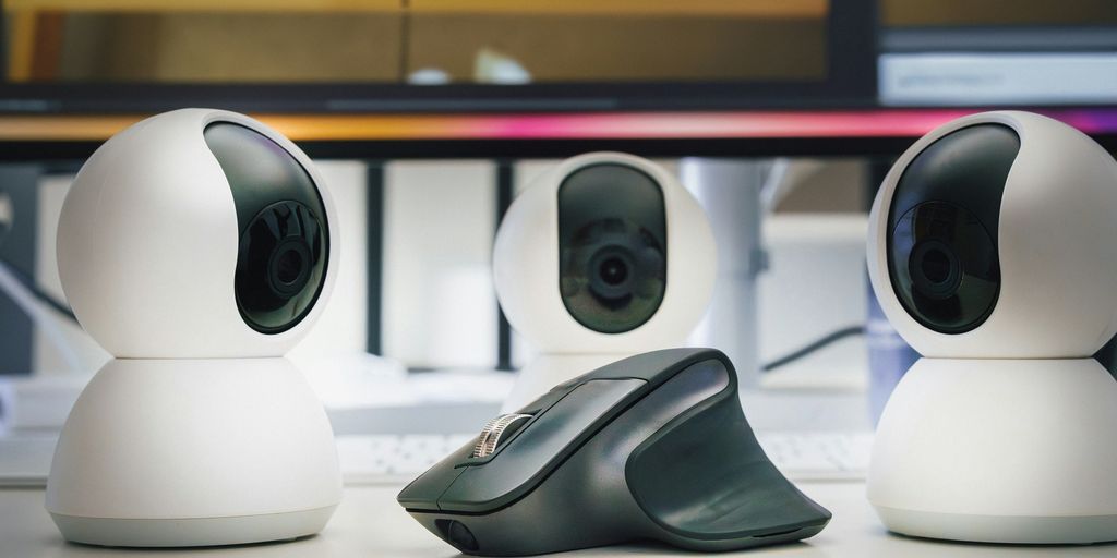 A group of three cameras sitting on top of a table